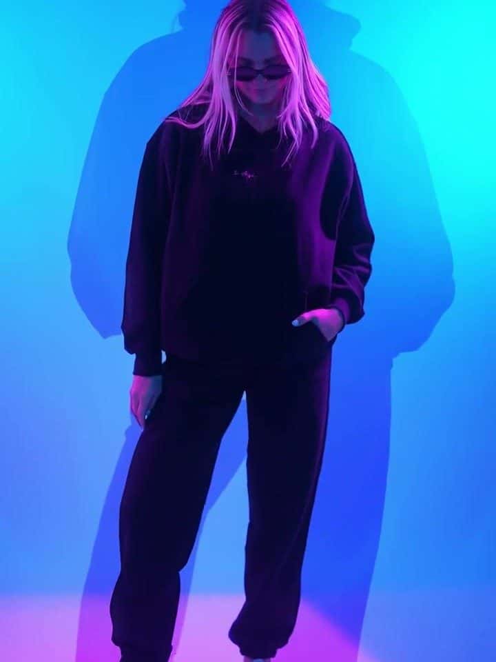 A model in Bodega Boyz apparel against a blue lit studio wall